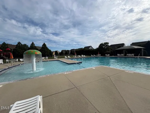 a view of yard with swimming pool and seating