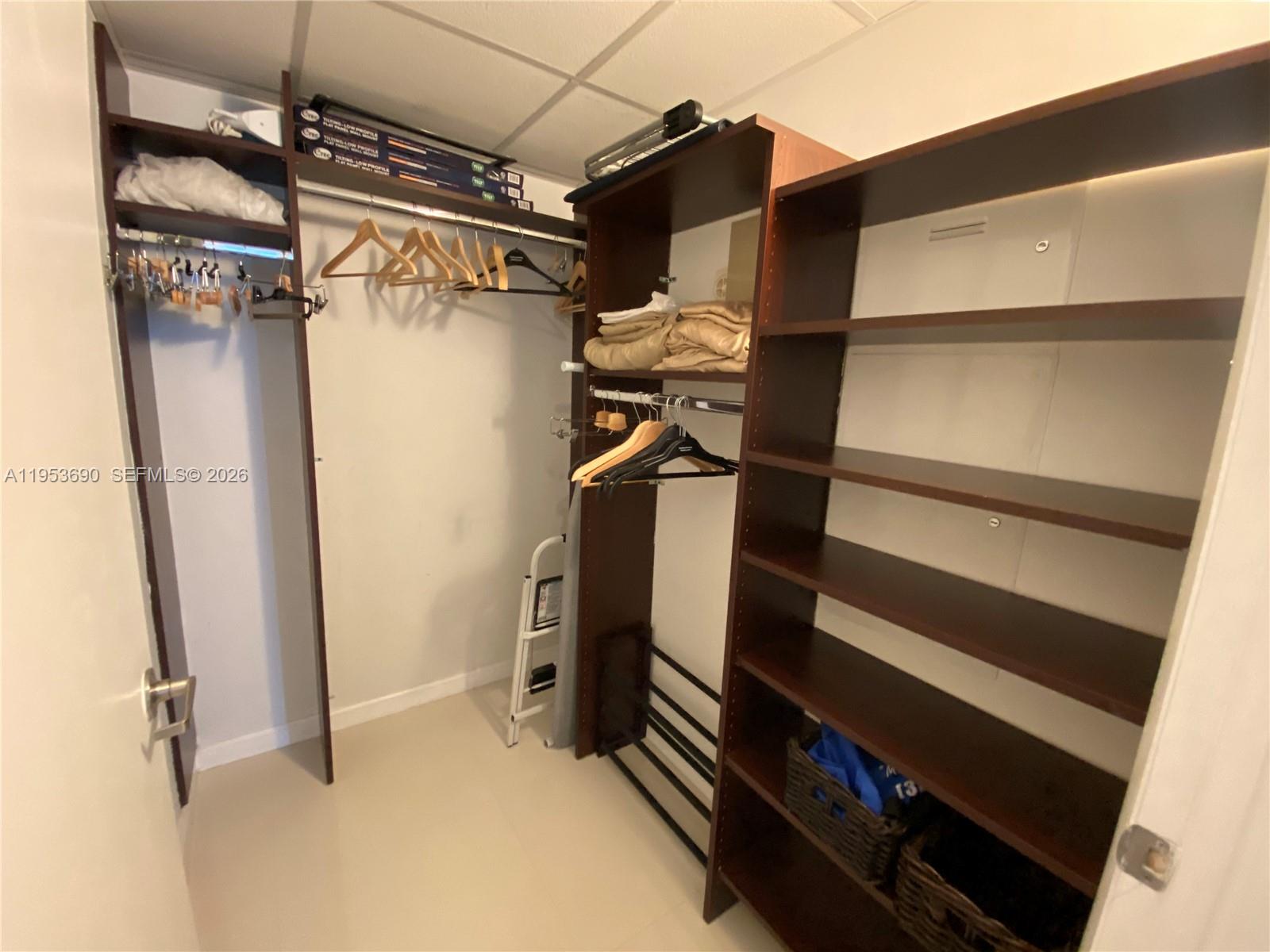 465 Brickell Avenue, Unit 3004 Miami, FL 33131 - Photo 12 of 17 a view of walk in closet with clothes and shoes