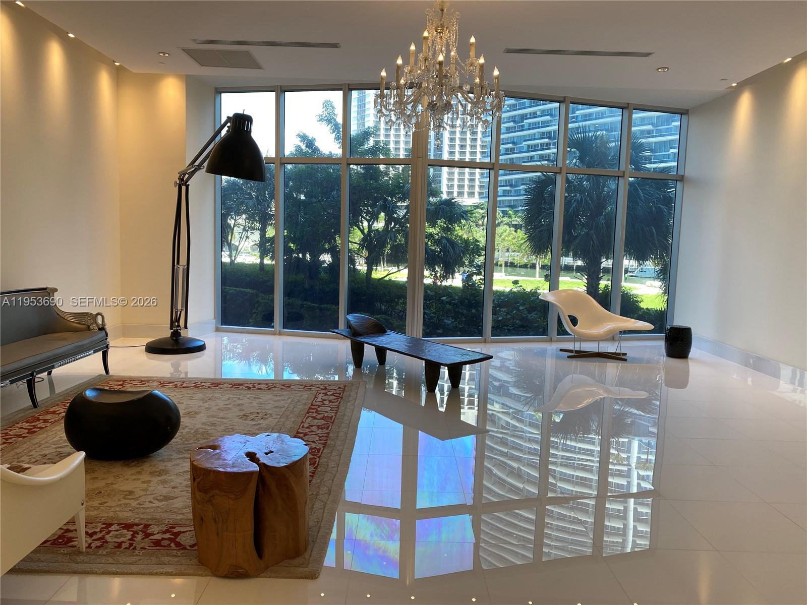 465 Brickell Avenue, Unit 3004 Miami, FL 33131 - Photo 15 of 17 a living room with fireplace furniture and a chandelier