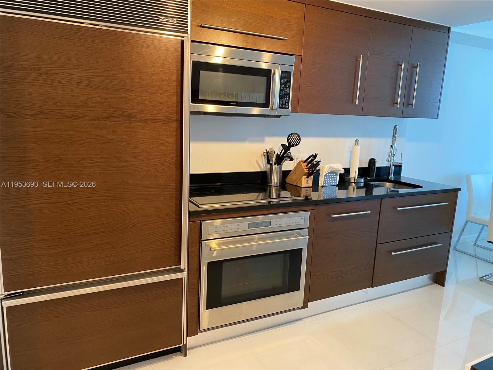 465 Brickell Avenue, Unit 3004 Miami, FL 33131 - Photo 8 of 17 a kitchen with granite countertop stainless steel appliances and cabinets