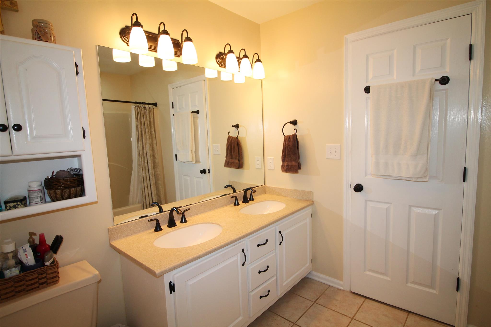 1539 West Harpeth Road Franklin, TN 37064 - Photo 16 of 30 a bathroom with double vanity sinks a vanity two mirror and shower