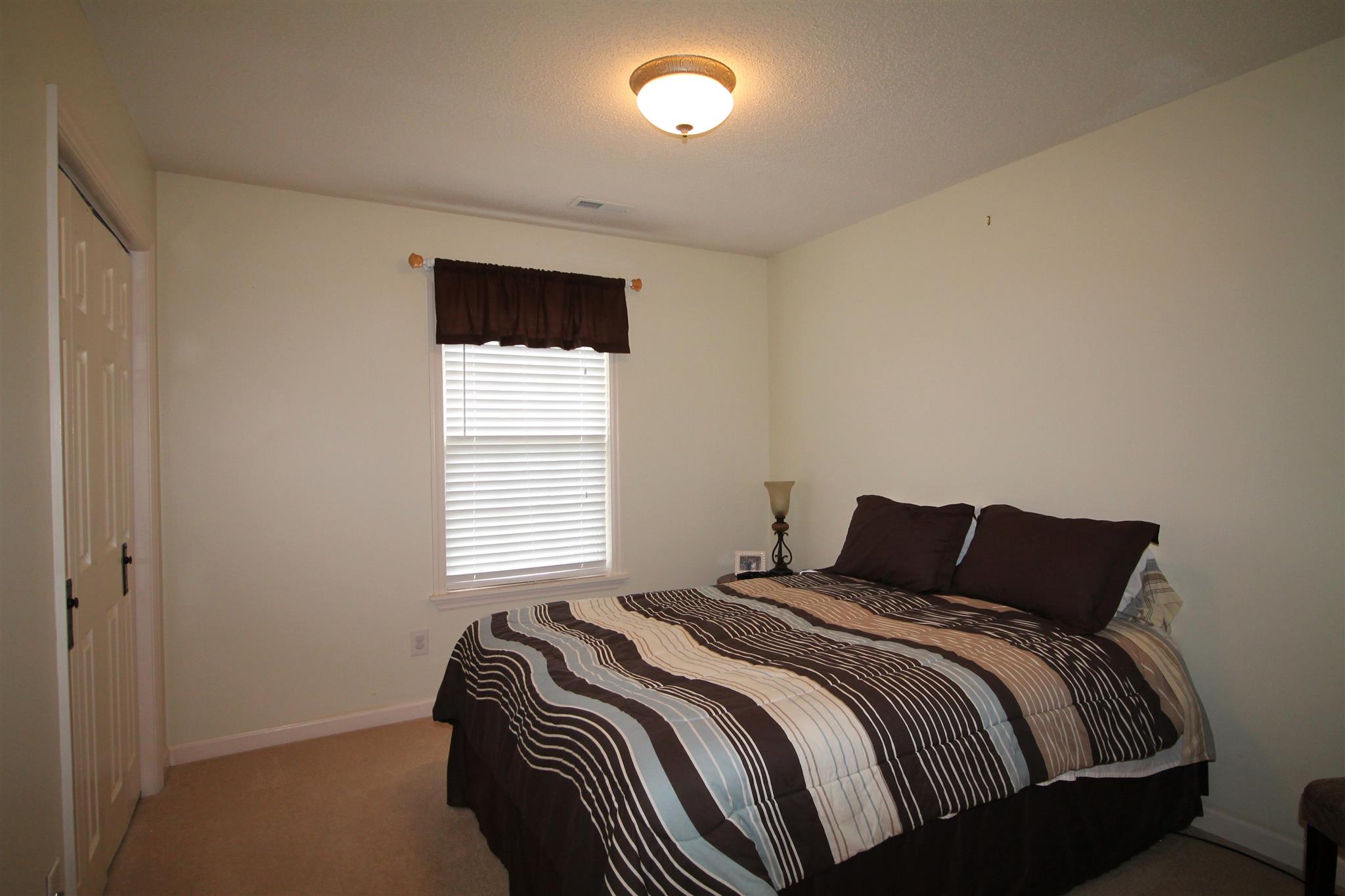 1539 West Harpeth Road Franklin, TN 37064 - Photo 19 of 30 a bedroom with a bed and window
