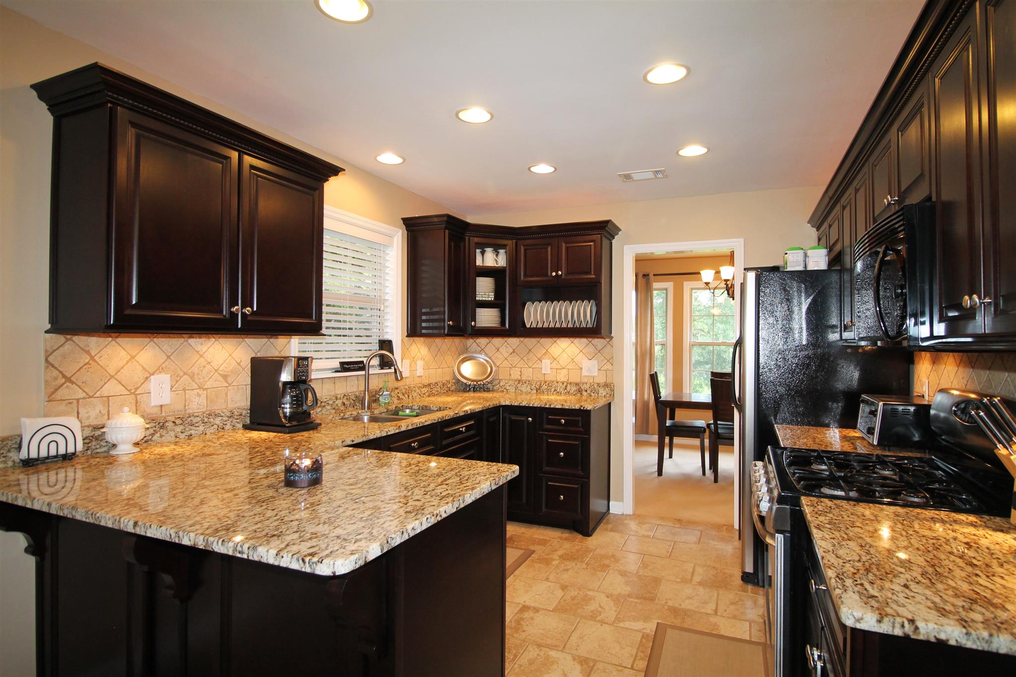 1539 West Harpeth Road Franklin, TN 37064 - Photo 8 of 30 a kitchen with a sink a stove and cabinets