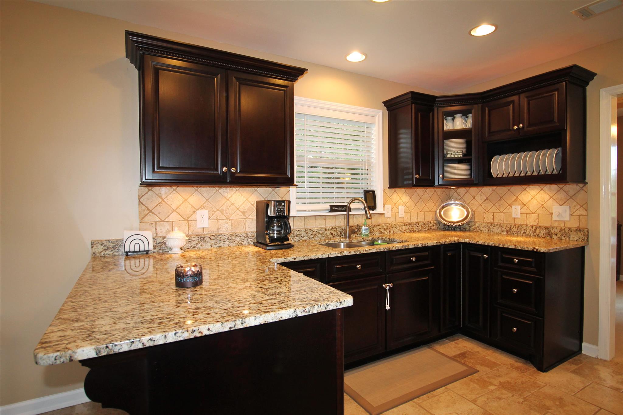 1539 West Harpeth Road Franklin, TN 37064 - Photo 9 of 30 a kitchen with a sink a stove and cabinets