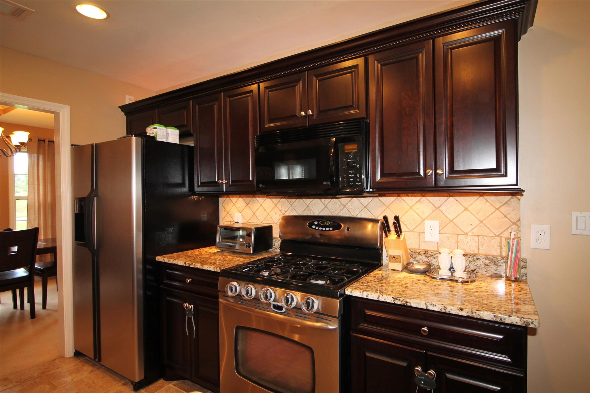 1539 West Harpeth Road Franklin, TN 37064 - Photo 10 of 30 a kitchen with granite countertop a stove and a microwave