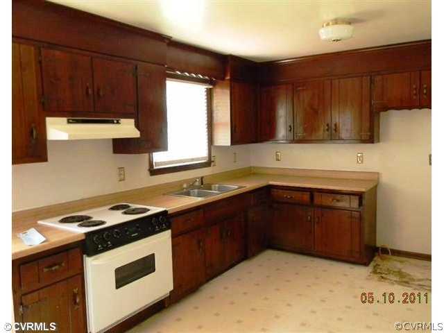 17850 Willowynde Road Chester, VA 23836 - Photo 2 of 5 a kitchen with a sink stove top oven and cabinets