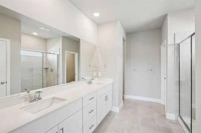 a spacious bathroom with a double vanity sink mirror and double