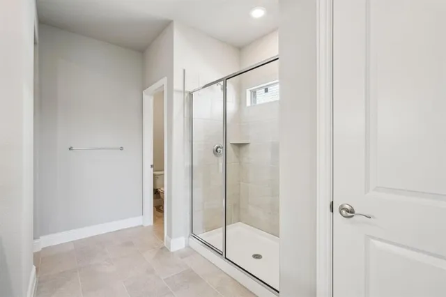 a bathroom with a glass shower door