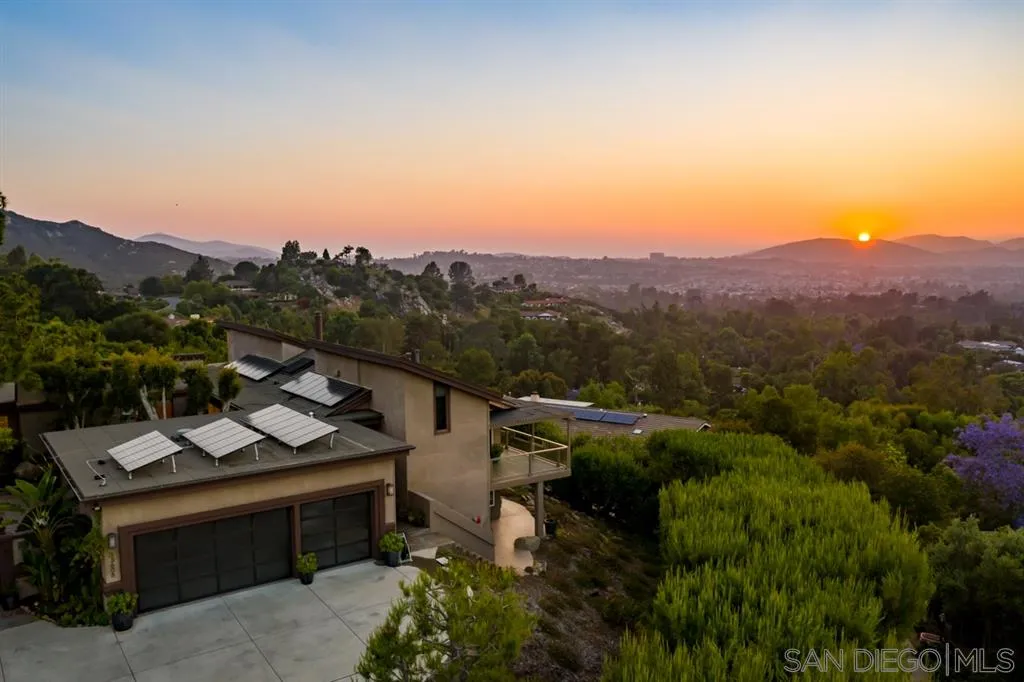 a view of a city with lush green forest