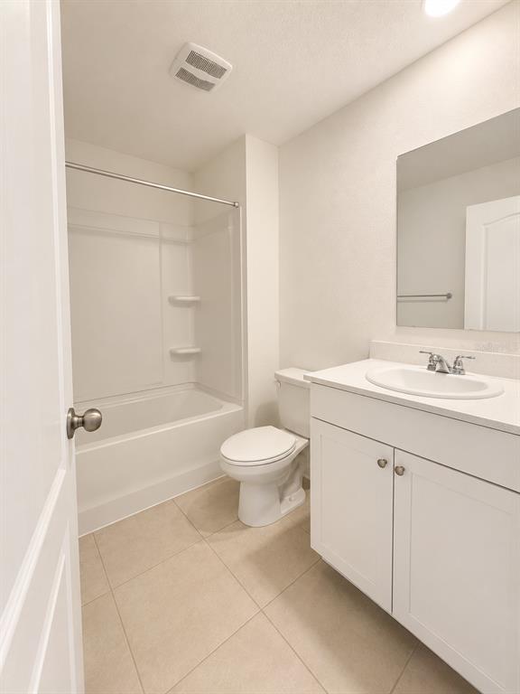 339 Redbud Road Palm Coast, FL 32137 - Photo 12 of 22 a bathroom with a sink toilet and shower