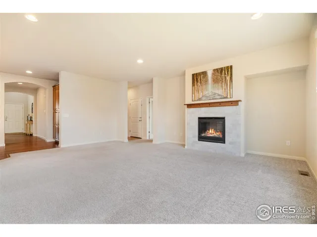 a view of empty room with a fireplace