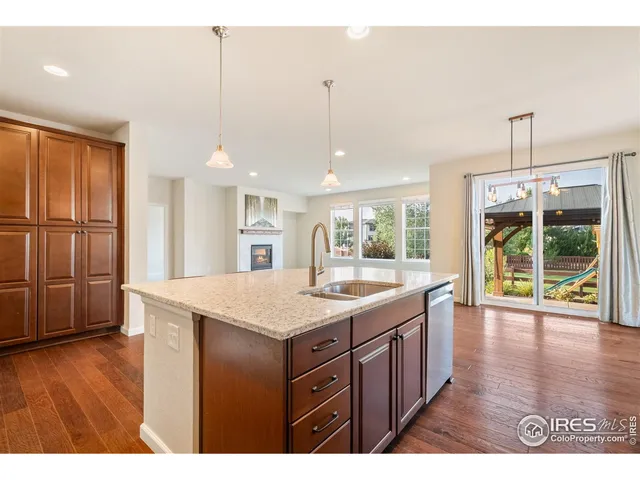 a kitchen with a wooden floor and window