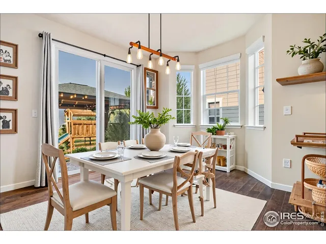 a dining room with furniture a chandelier and wooden floor