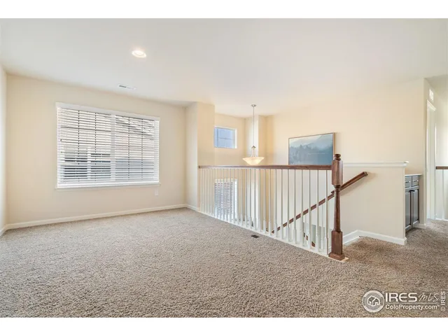 a spacious bedroom with a bed a window and a couch