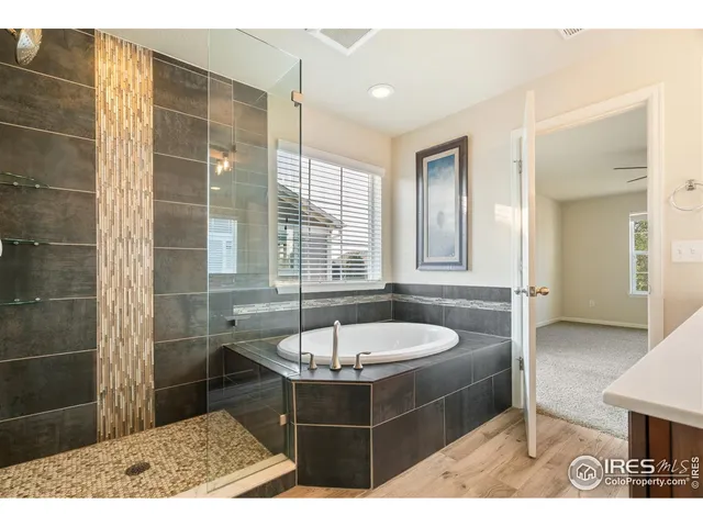 a bathroom with a tub shower and sink