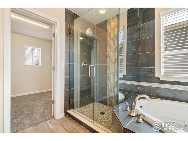 a bathroom with a granite countertop sink a large mirror and a