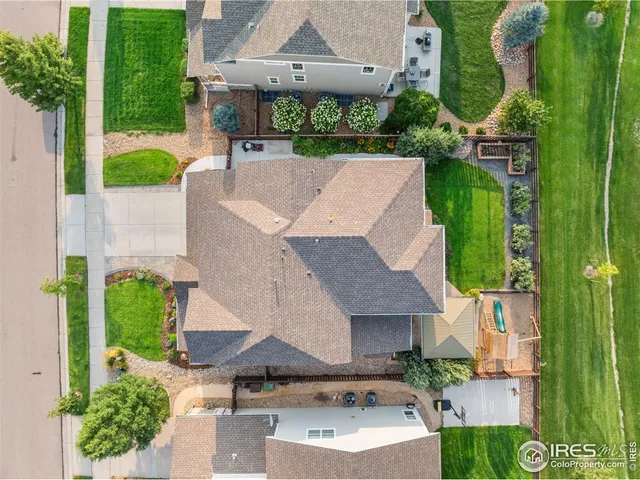 an aerial view of a house with a garden and swimming pool