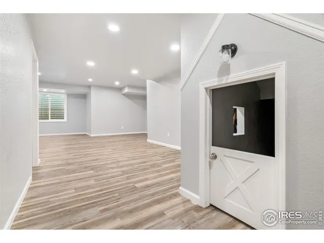 a view of an empty room with wooden floor