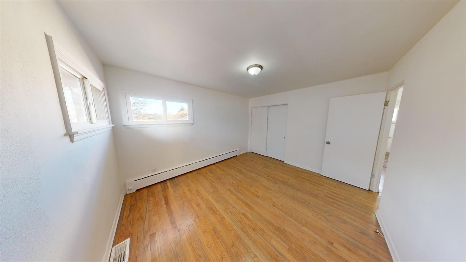 608 East Ridge Road Gary, IN 46409 - Photo 9 of 27 wooden floor in an empty room with a window