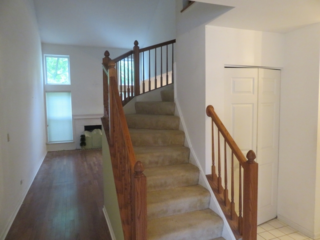 2116 Peach Tree Lane, Unit 4243 Algonquin, IL 60102 - Photo 15 of 25 a view of a hallway with wooden floor and stairs