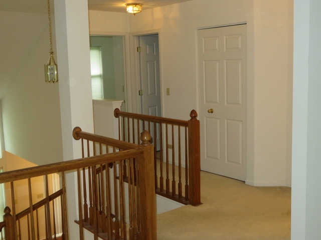 2116 Peach Tree Lane, Unit 4243 Algonquin, IL 60102 - Photo 17 of 25 a view of a hallway with wooden floor