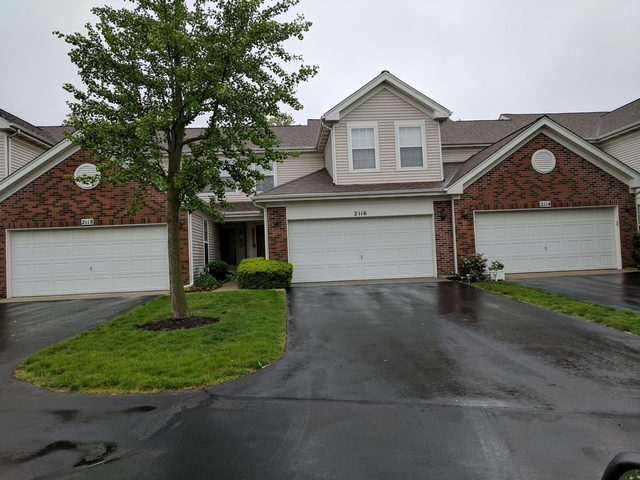 2116 Peach Tree Lane, Unit 4243 Algonquin, IL 60102 - Photo 25 of 25 a front view of a house with a yard and garage