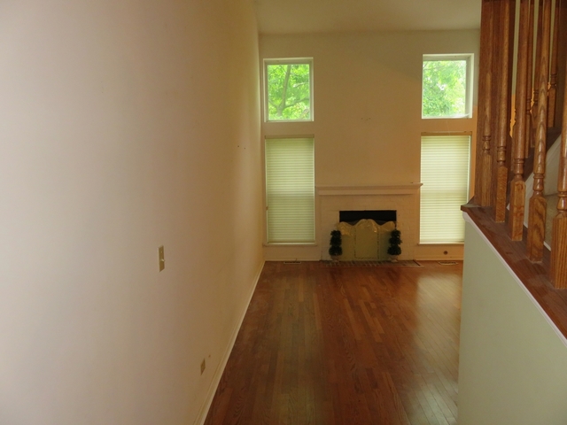 2116 Peach Tree Lane, Unit 4243 Algonquin, IL 60102 - Photo 4 of 25 a view of a hallway with wooden floor and a fireplace