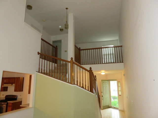 2116 Peach Tree Lane, Unit 4243 Algonquin, IL 60102 - Photo 7 of 25 a view of a hallway with windows and stairs