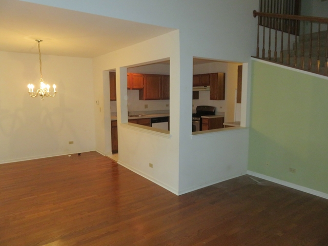 2116 Peach Tree Lane, Unit 4243 Algonquin, IL 60102 - Photo 8 of 25 a view of a room with a hanging light and kitchen
