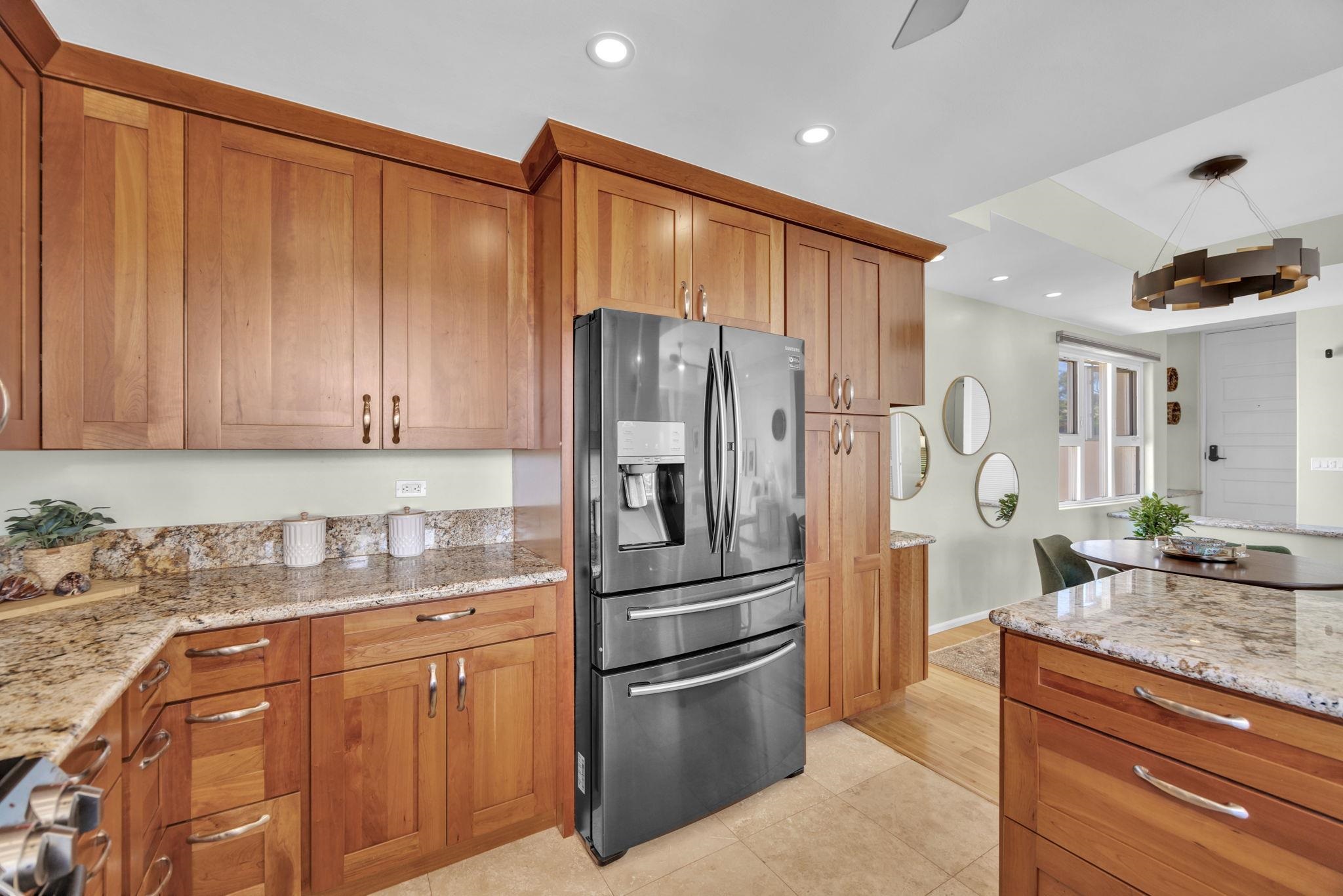 3150 Wailea Alanui Drive, Unit 2504 Kihei, HI 96753 - Photo 14 of 47 a kitchen with stainless steel appliances granite countertop a refrigerator and a sink