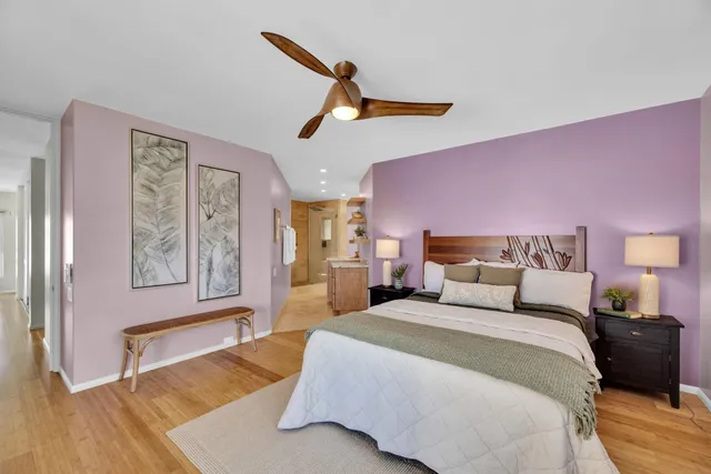 a bedroom with a bed and wooden floor