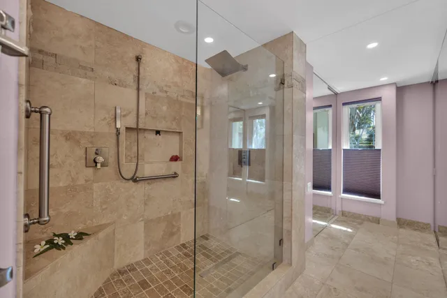 a bathroom with a glass shower door and a shower