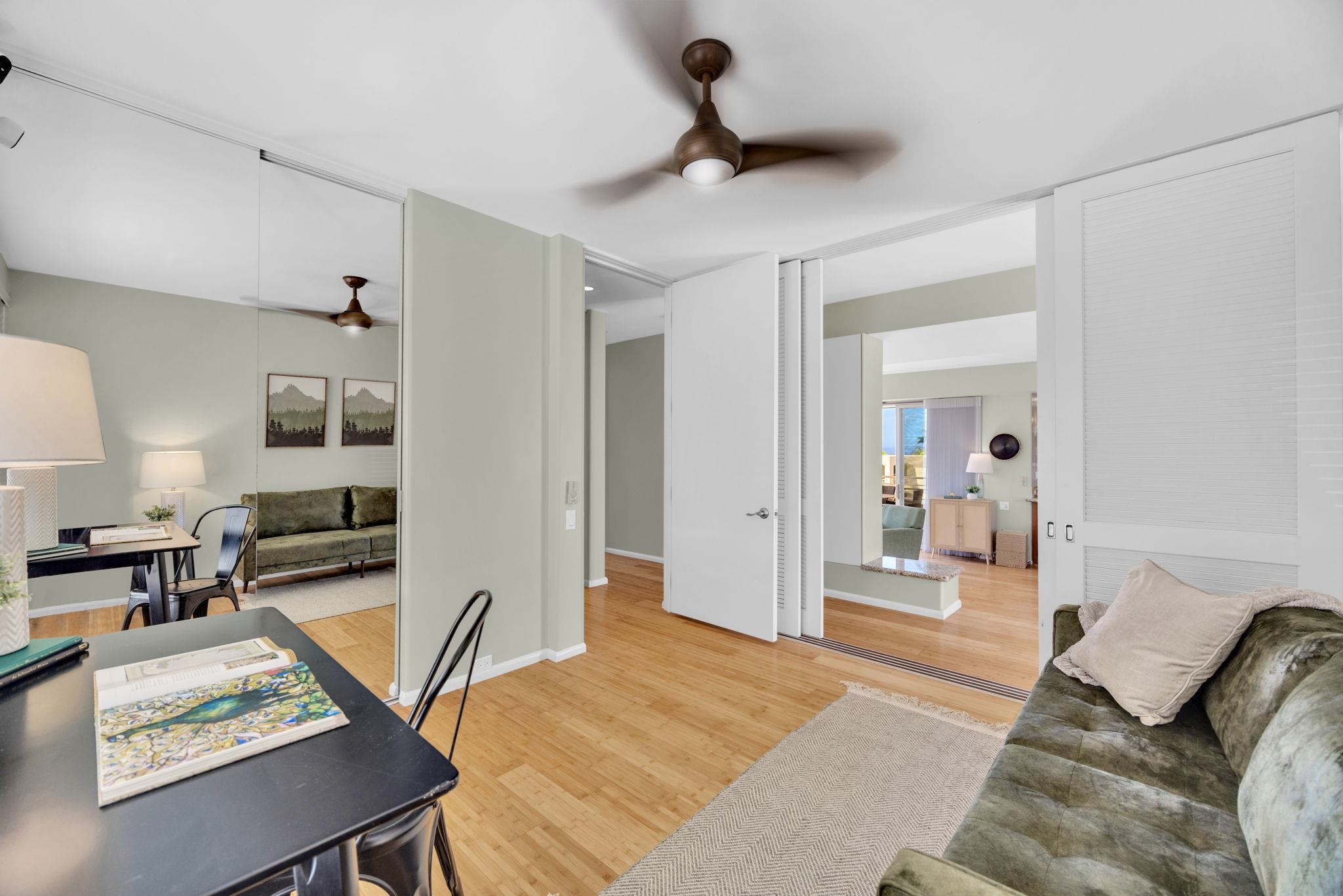 3150 Wailea Alanui Drive, Unit 2504 Kihei, HI 96753 - Photo 37 of 47 a bedroom with furniture and a wooden floor