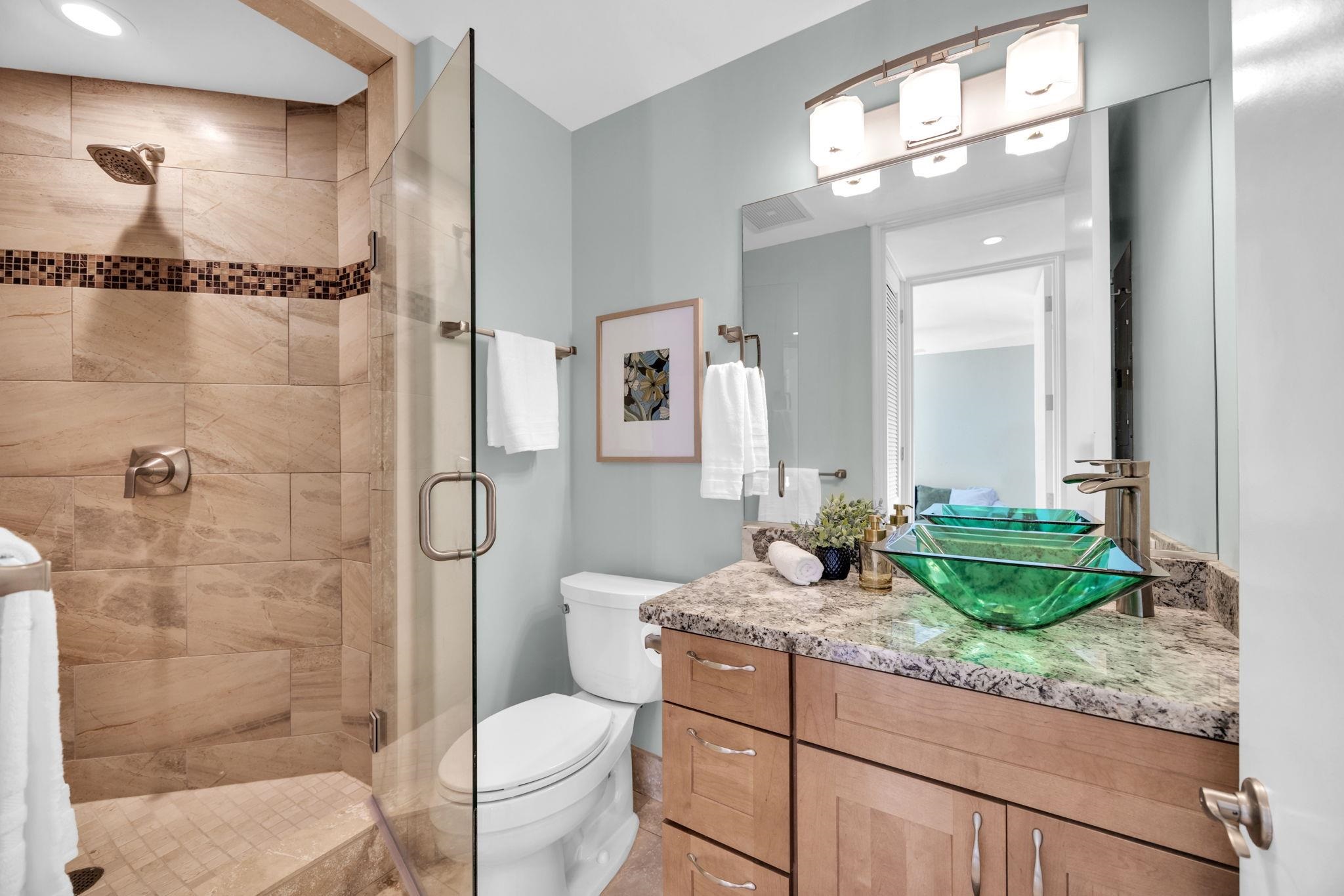 3150 Wailea Alanui Drive, Unit 2504 Kihei, HI 96753 - Photo 39 of 47 a bathroom with a granite countertop sink toilet and shower