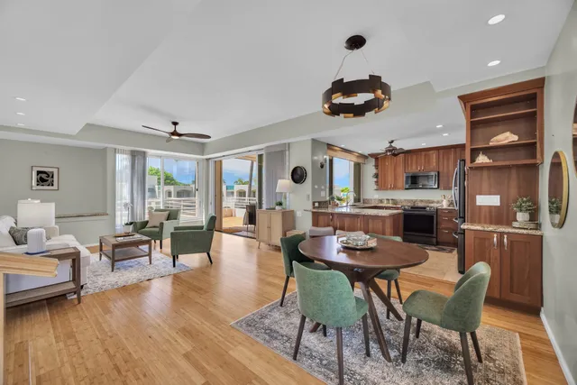 a dining room with wooden floor and chandelier