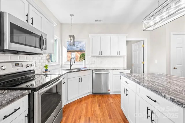 a living room with furniture fireplace and a large window