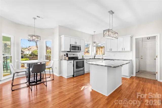 a living room with furniture fireplace and a large window