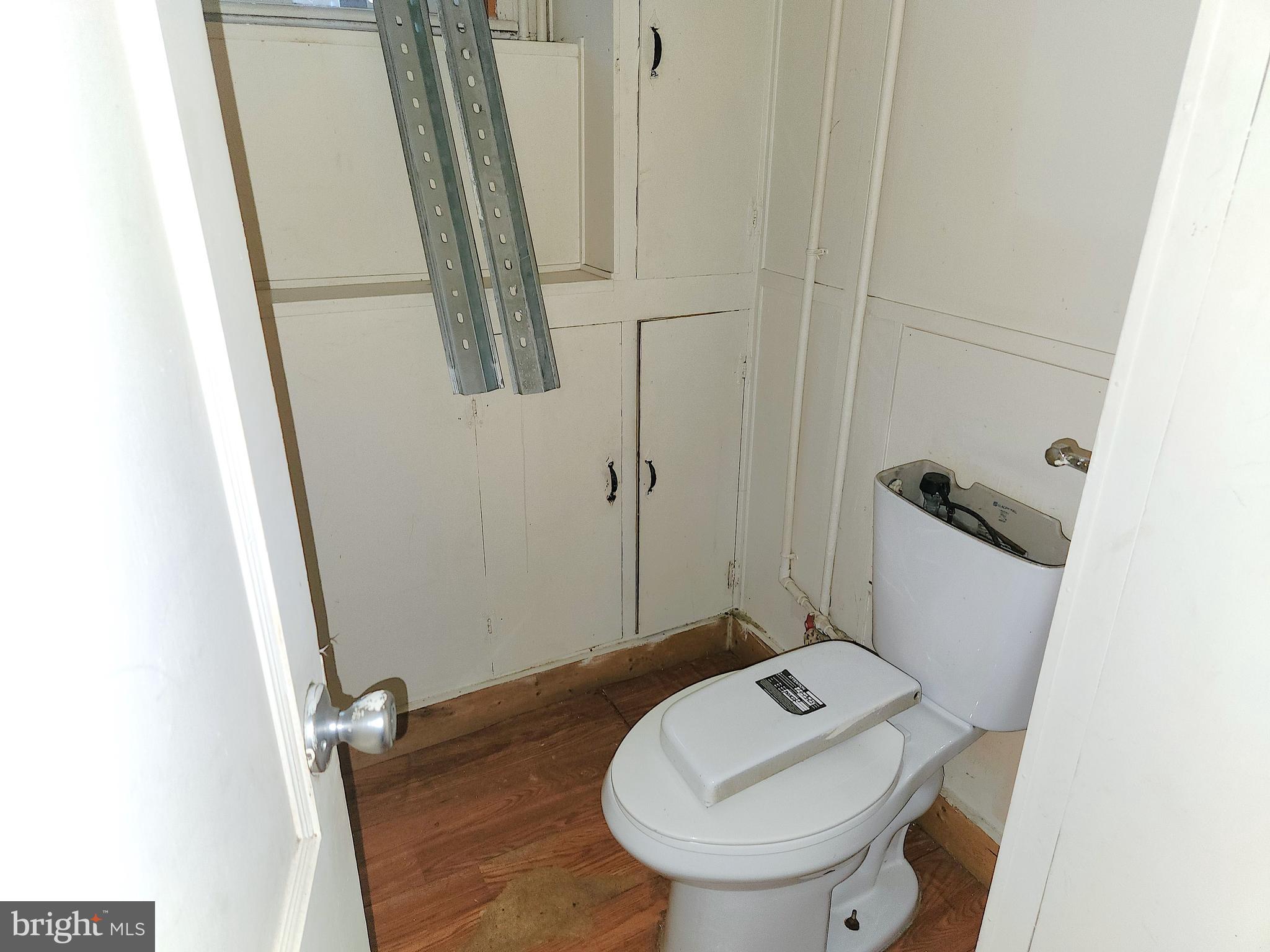 3336 Chesterfield Avenue Baltimore, MD 21213 - Photo 15 of 16 a bathroom with a sink a toilet and a mirror
