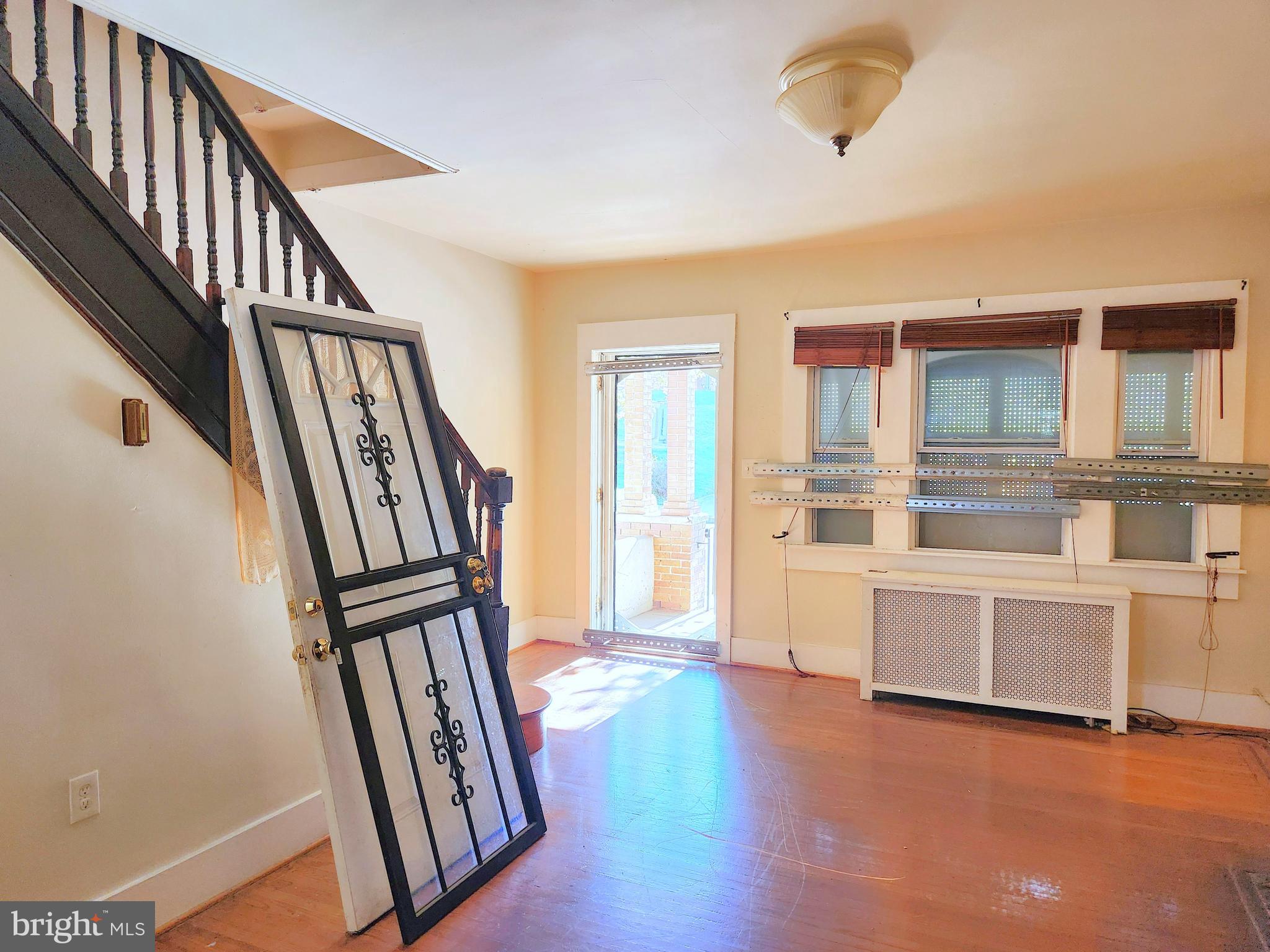 3336 Chesterfield Avenue Baltimore, MD 21213 - Photo 3 of 16 a view of a livingroom with wooden floor and staircase