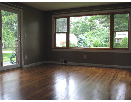 168 Woodcrest Road Springfield, MA 01129 - Photo 8 of 13 a view of an empty room with wooden floor and a window