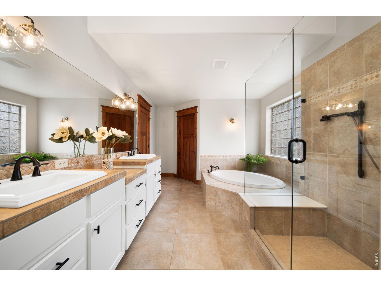 316 Wood Street Fort Collins, CO 80521 - Photo 23 of 50 a spacious bathroom with a double vanity sink and mirror
