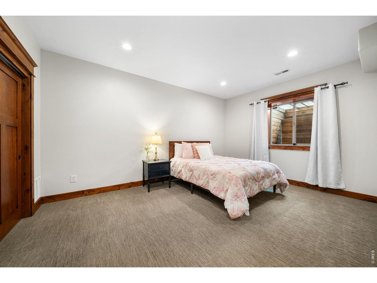 316 Wood Street Fort Collins, CO 80521 - Photo 36 of 50 a bed sitting in a spacious bedroom next to a window