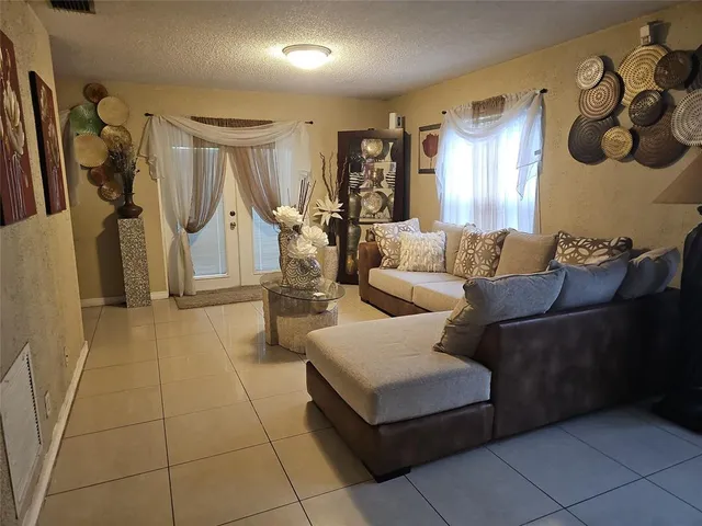 a living room with furniture and a gym machine