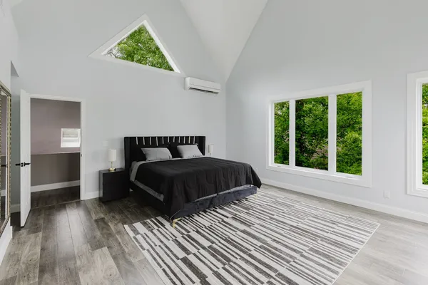 a bedroom with a bed and a chandelier
