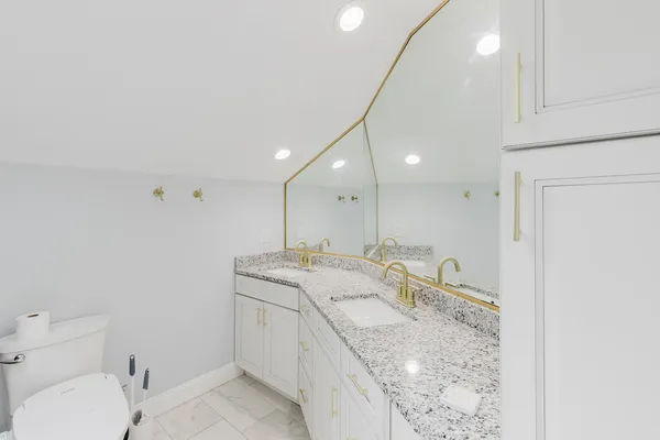 a bathroom with a double vanity sink mirror and