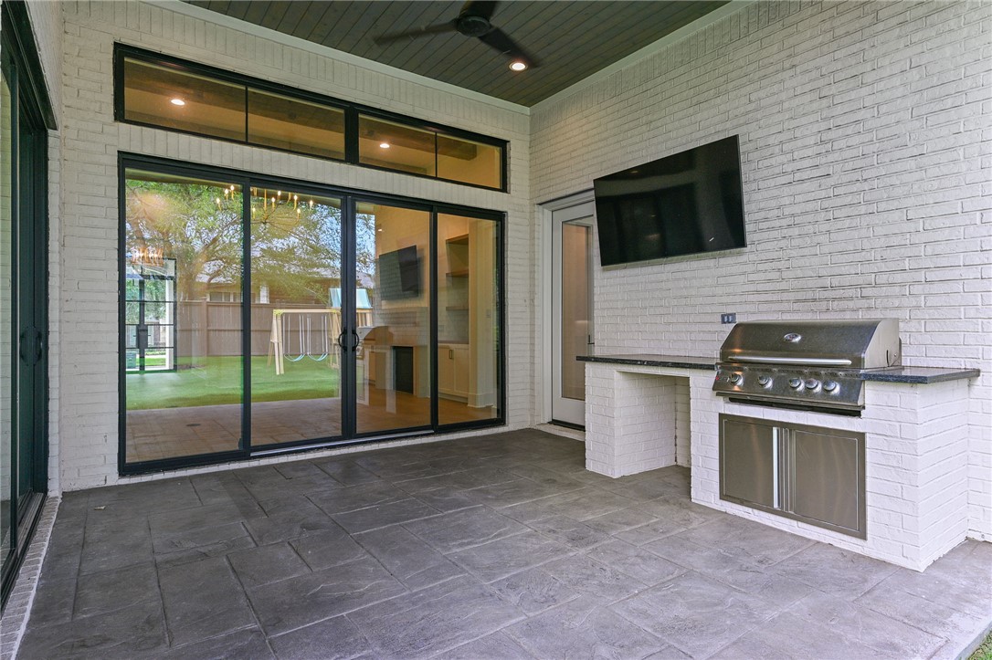 5115 Inverness Drive Bryan, TX 77802 - Photo 25 of 28 Covered patio featuring a grill, ceiling fan, and tv connections