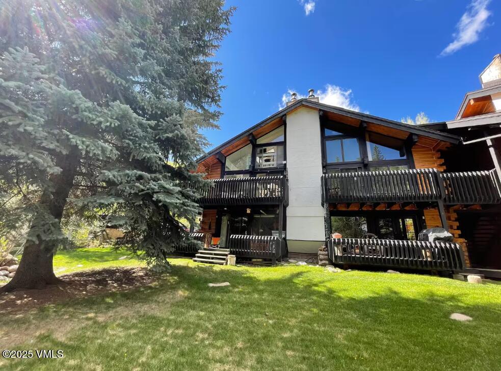 2958 South Frontage Road West, Unit B5 Vail, CO 81657 - Photo 13 of 13 a view of an house with backyard and a tree