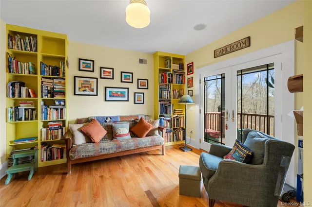 a living room with furniture and a book shelf