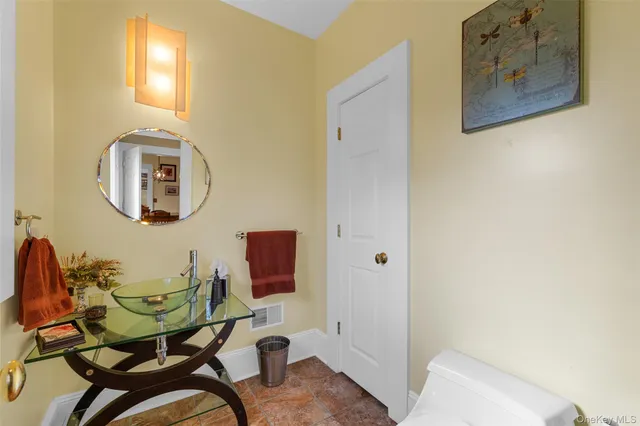 a bathroom with a sink mirror and vanity