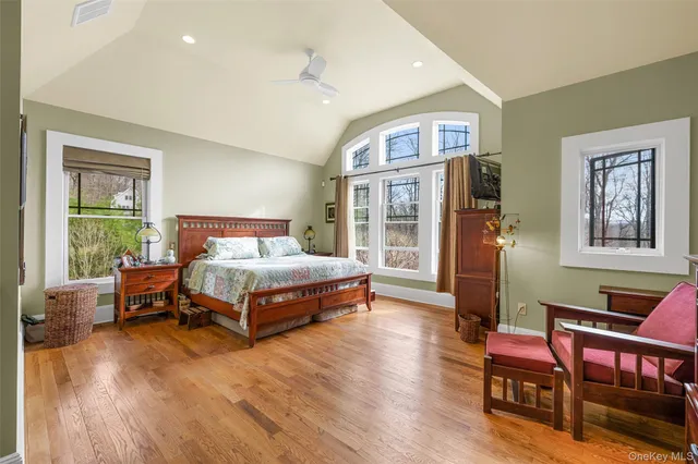 a bedroom with a bed wooden floor and window